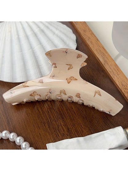 Top view of Beau brown butterfly print claw clip showing butterfly pattern