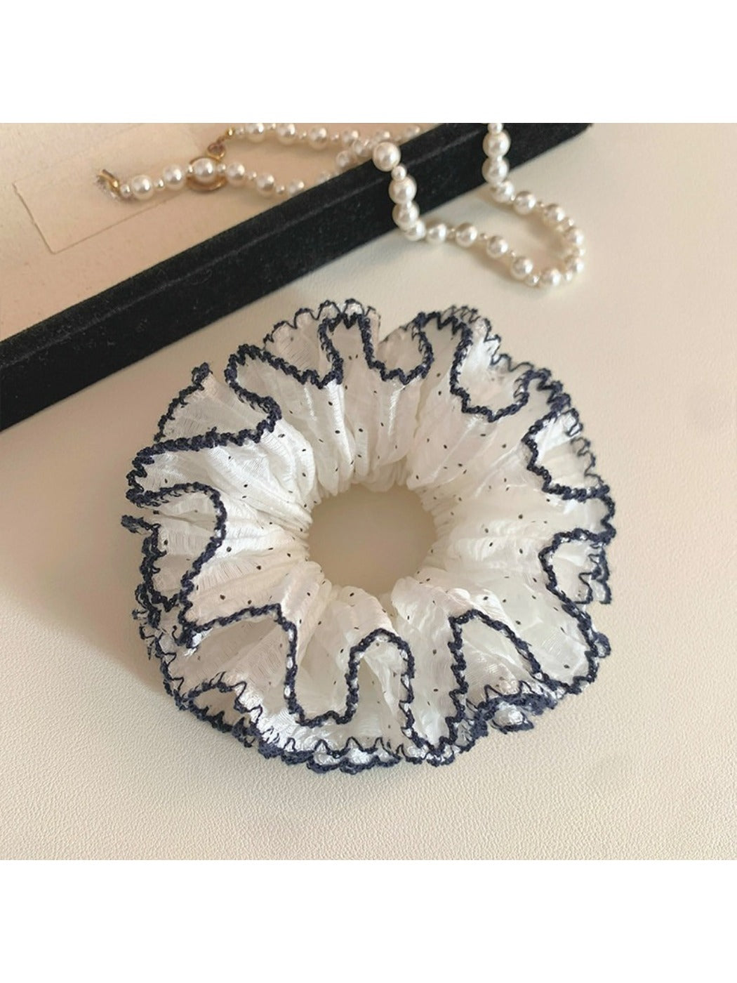 Four tier ruffled scrunchie displayed on a white background