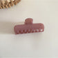 Beau pastel purple rectangular hair clip with metal clasp on white surface