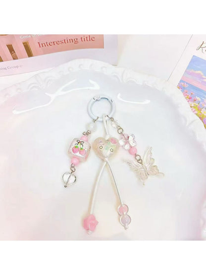 Heart shaped butterfly charm keychain displayed hanging from a hook