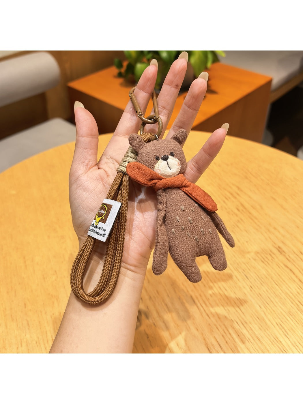 Top view of the bear keychain highlighting the scarf and ears