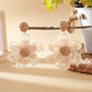 Earedge raffia flower earrings styled with casual outfit on model