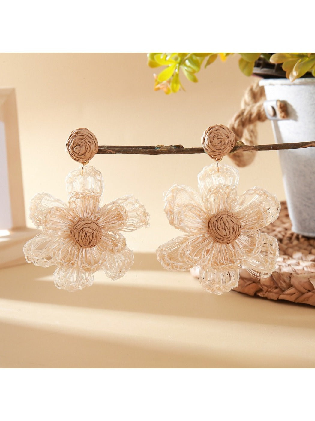 Earedge raffia flower earrings styled with casual outfit on model
