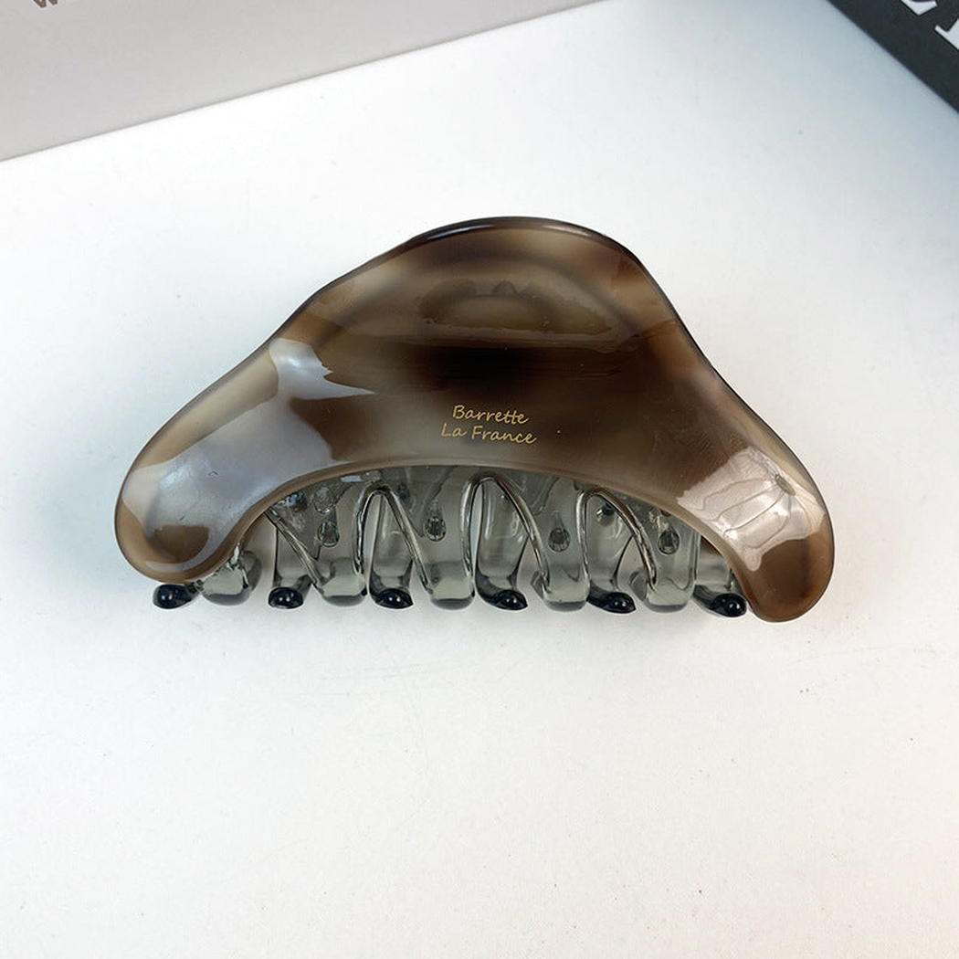 Gray tortoise-pattern triangle hair claw, front view