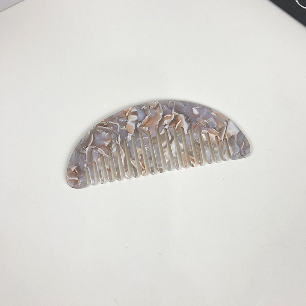 Gray and purple veined pocket comb, front view