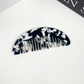 Black and white geometric pocket comb, front view