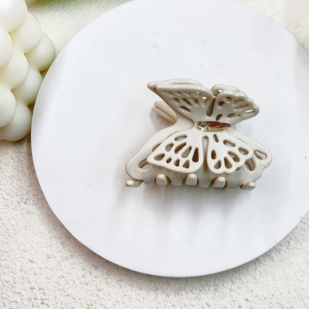 Cream butterfly-shaped openwork hair claw clip