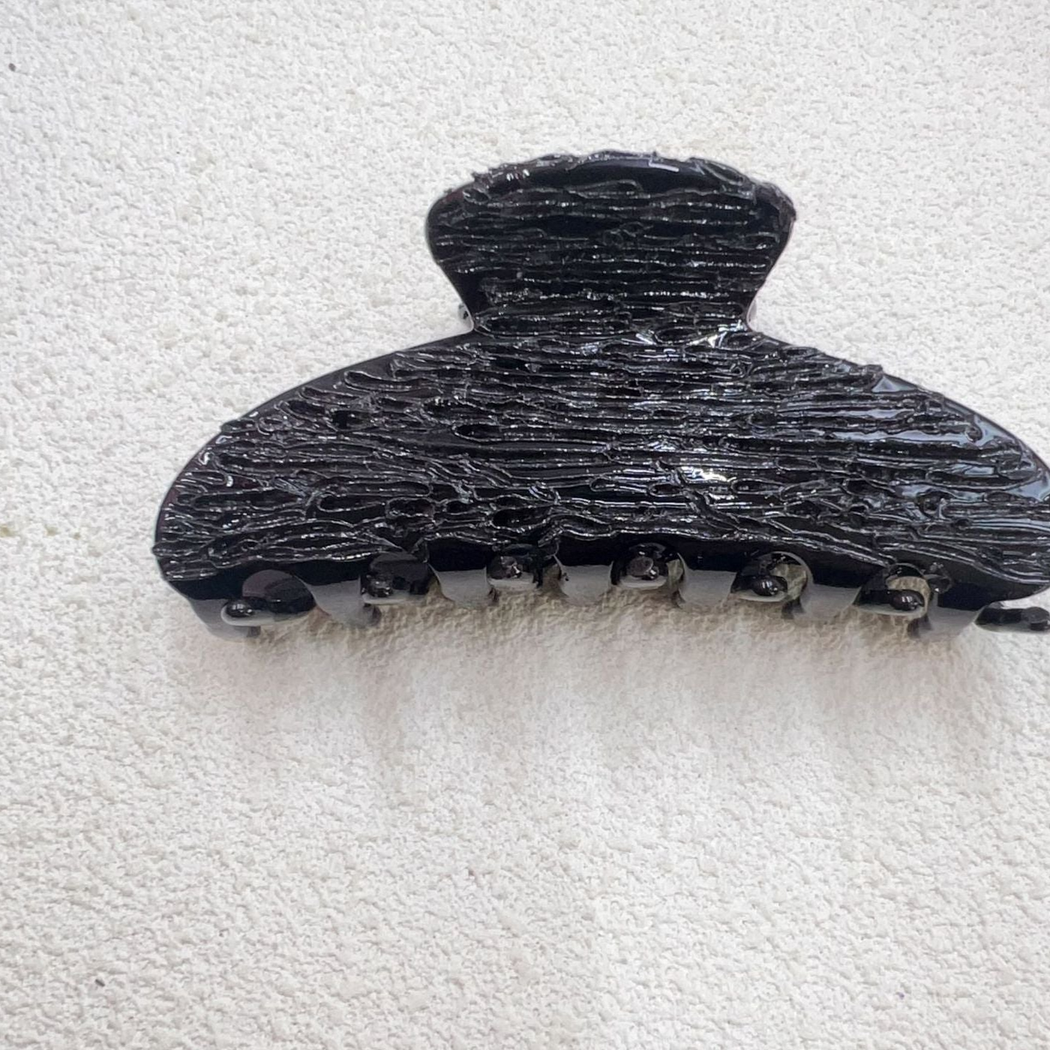 Black textured croissant-shaped hair claw clip