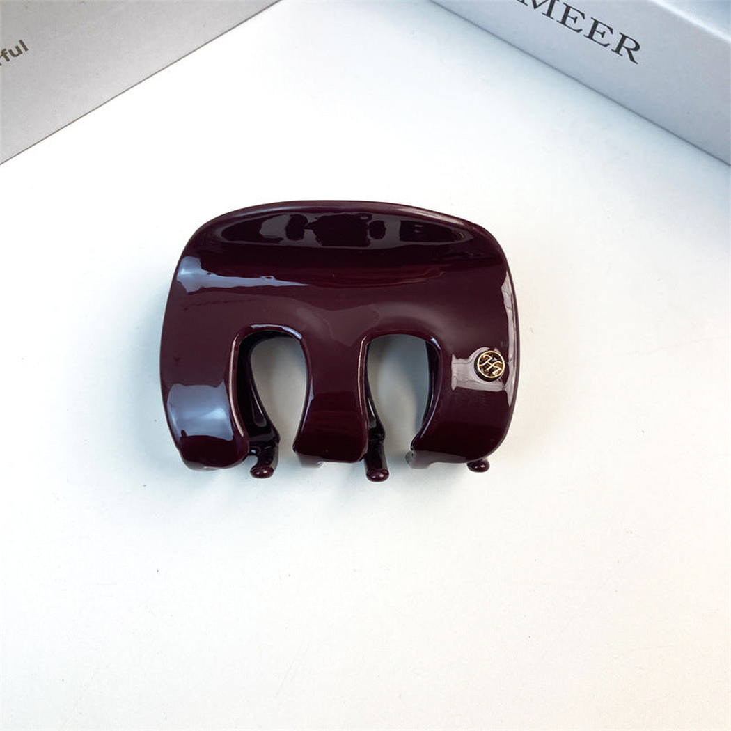 Burgundy letter-detail hair claw, front view