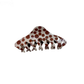 Polka dot spine-shaped hair claw clip on white background
