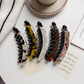 Beau - Elongated Curved Mottled Pattern Banana Clip