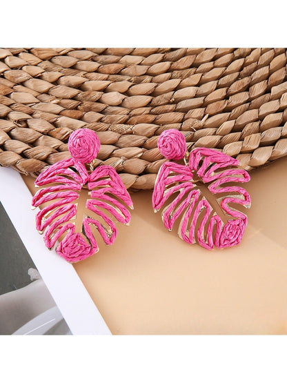 Earedge raffia woven hollow leaf shaped earrings displayed with natural decor