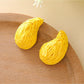 Close-up of the back of raffia water drop shaped stud earrings showing posts