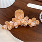 Beau elegant floral half round claw clip photographed with soft lighting