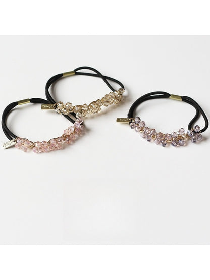 Gifty beaded hair tie displayed on a white background showing round and faceted beads