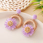 Top view of Earedge raffia daisy shaped stud earrings showing symmetrical design