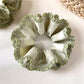 Close-up of delicate green double layer scrunchie with soft fabric texture