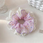 Gifty polka dot ruched scrunchie in black and white shown with matching hairpins