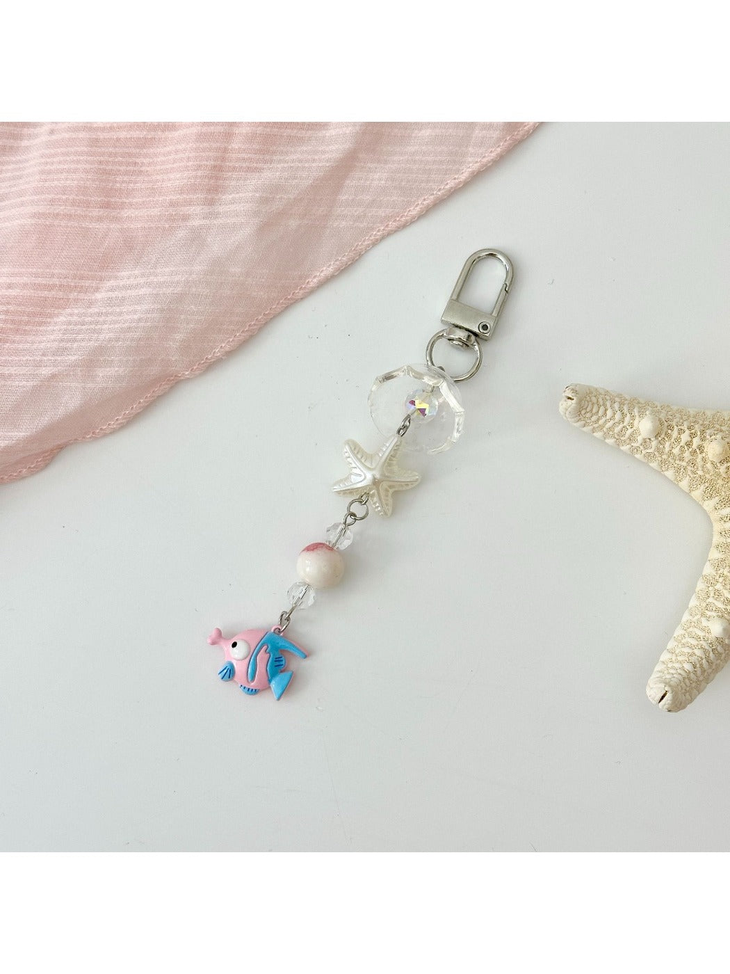 Yellow fish keychain displayed alongside other colored fish keychains