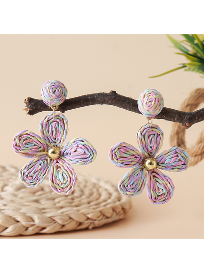 Earedge floral raffia woven vintage drop earrings hanging on a jewelry stand