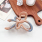 Beau ombre heart shaped bow claw clip photographed from above on a textured surface