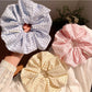 Textured scrunchie styled on a wrist as a casual accessory