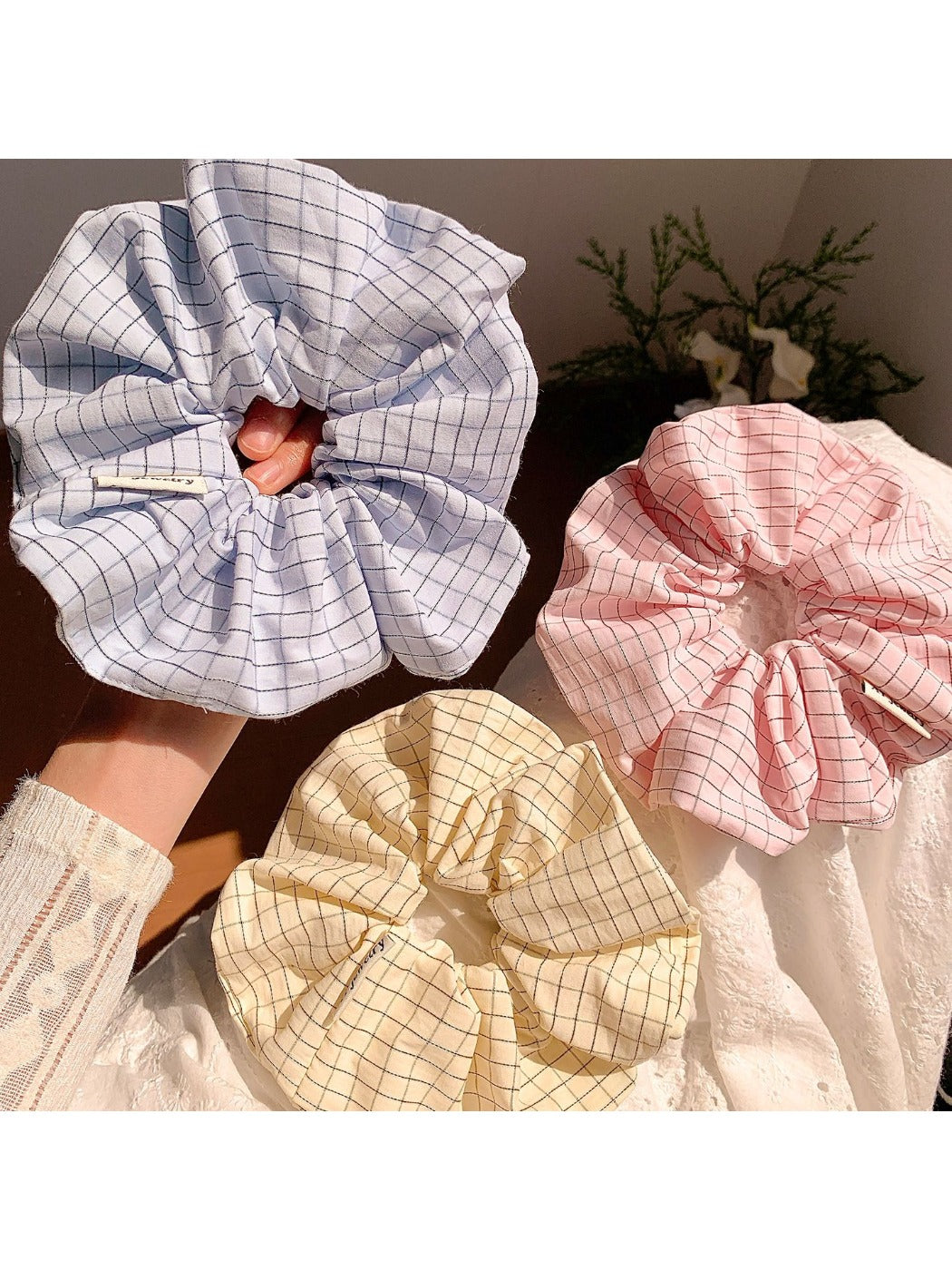 Textured scrunchie styled on a wrist as a casual accessory