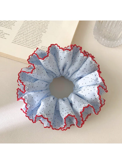 Gifty chic polka dot ruffle scrunchie in black and white on a white background