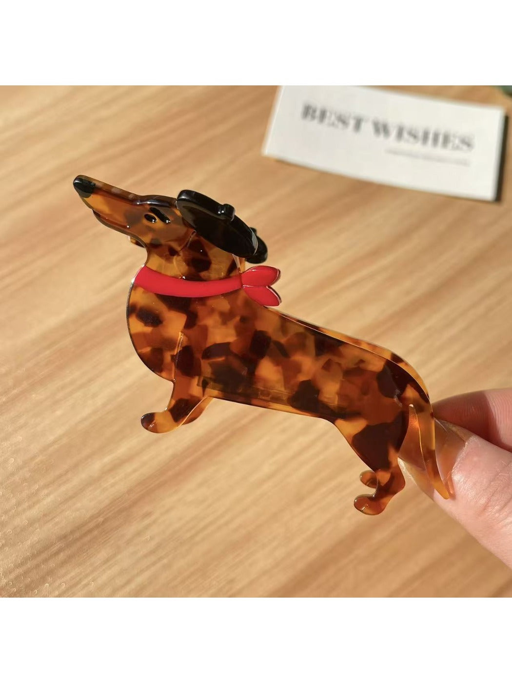Beau dachshund claw clip with visible teeth gripping mechanism in brown and black