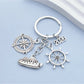 Side view of silver alloy steamship keychain showing hull and portholes
