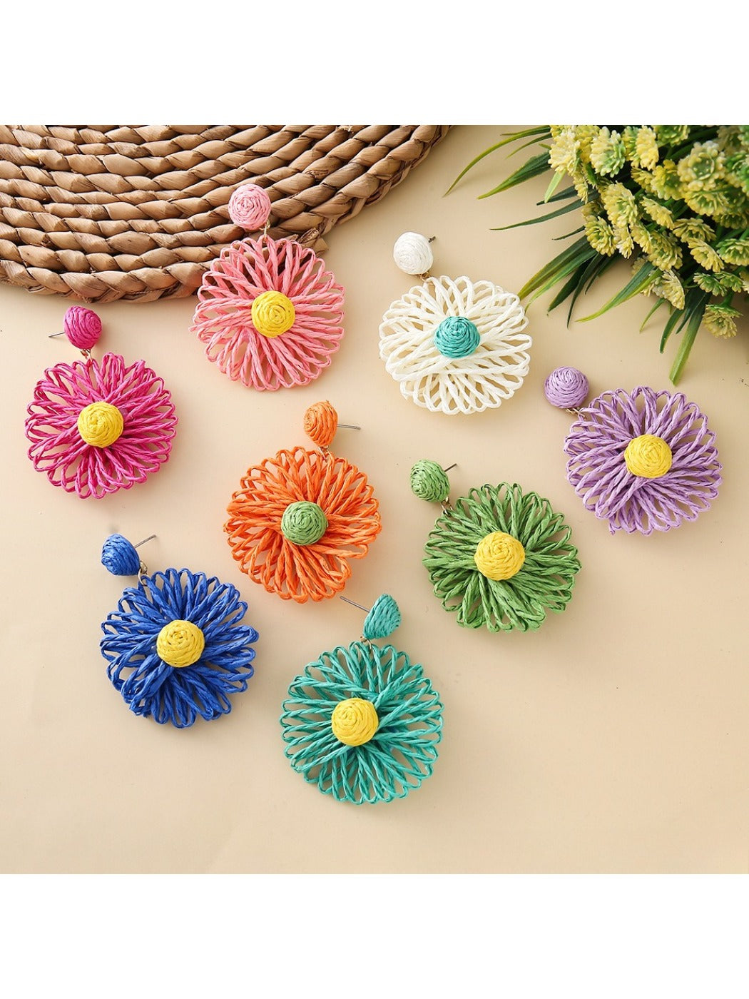 Close-up of raffia sunflower shaped earring with yellow petals and brown center