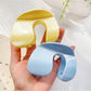 Beau hair claw clip held in hand demonstrating size and grip