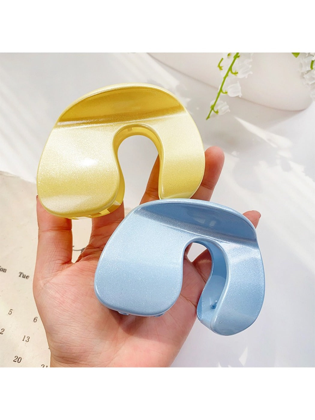 Beau hair claw clip held in hand demonstrating size and grip