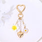 Heart flower keychain showing detailed stitching and gold ring