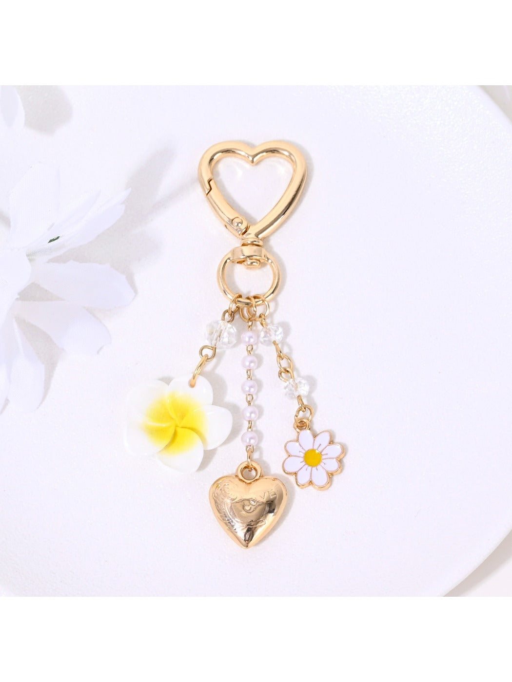 Heart flower keychain showing detailed stitching and gold ring