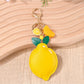 Lemon-shaped keychain displayed on a white background highlighting its shape and color