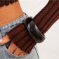 Lovra round bangle bracelet paired with other minimalist jewelry pieces