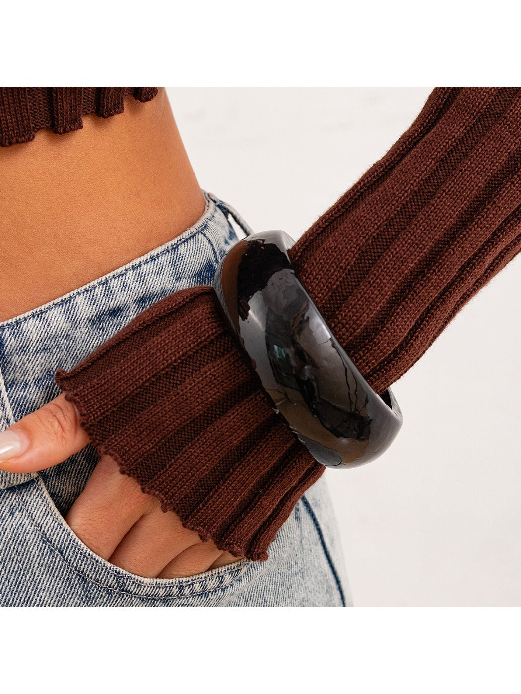 Lovra round bangle bracelet paired with other minimalist jewelry pieces
