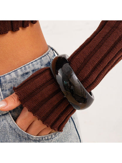 Lovra round bangle bracelet paired with other minimalist jewelry pieces