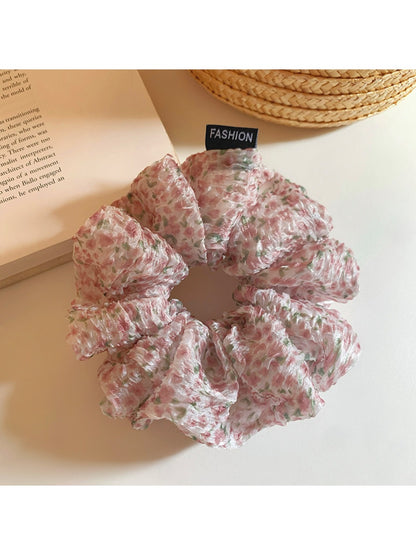 Pink floral print tulle scrunchie on a white background