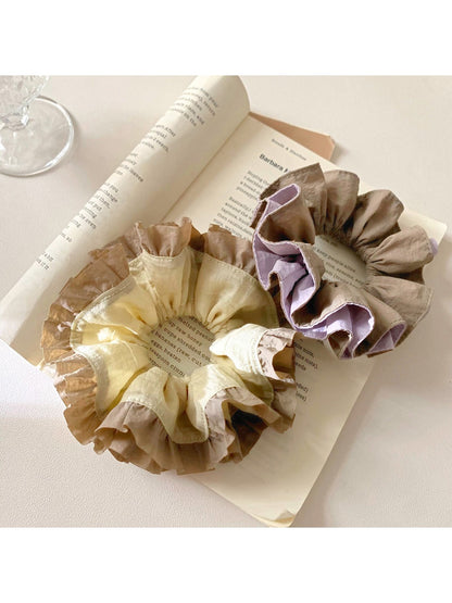 Close-up of vintage yellow ruffle scrunchie with textured fabric