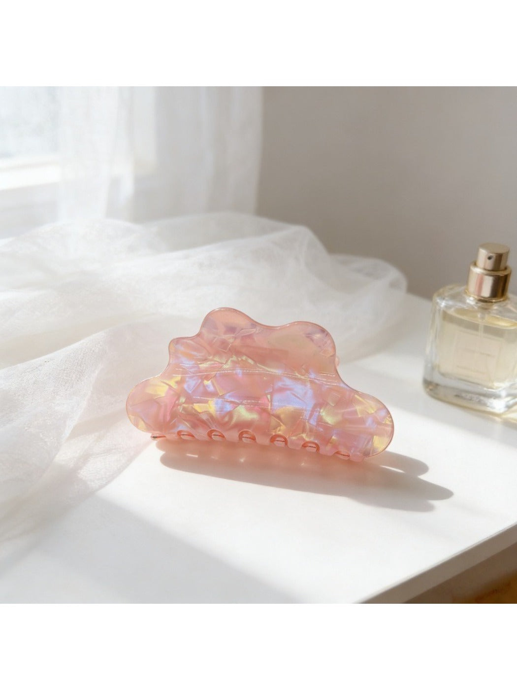 Beau holographic claw clip held in hand showing size and shine