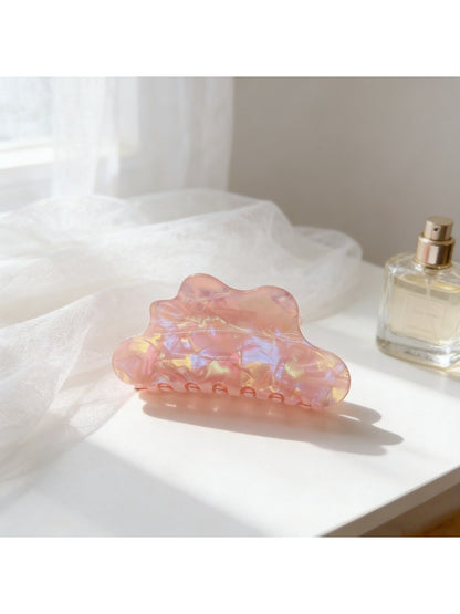 Beau holographic claw clip held in hand showing size and shine