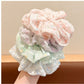 Gifty floral print scrunchie displayed on a wooden surface