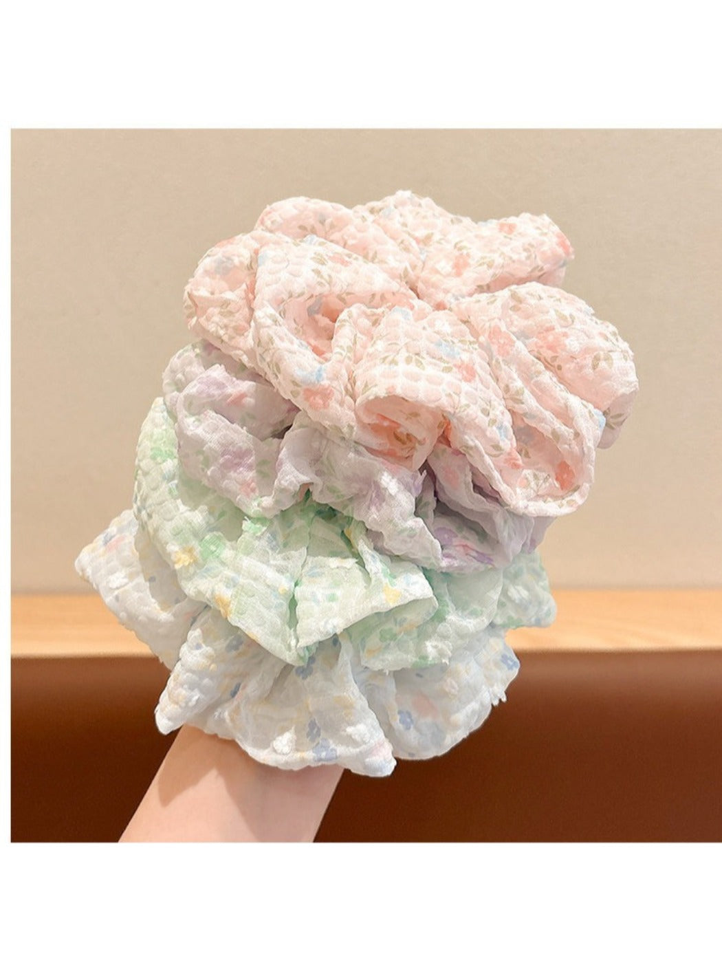 Gifty floral print scrunchie displayed on a wooden surface