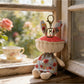 Keypus fabric doll keychain attached to a handbag zipper pull
