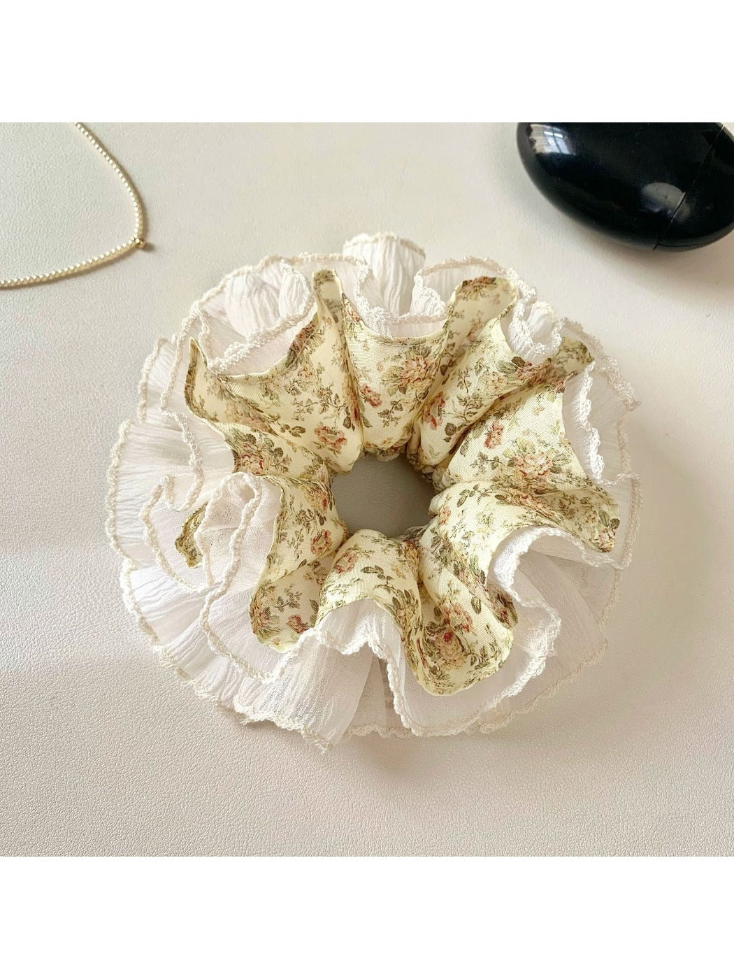Gifty vintage floral ruched scrunchie packaged in a clear plastic bag with branding