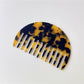 Camerow acetate hair comb with light reflecting off polished surface