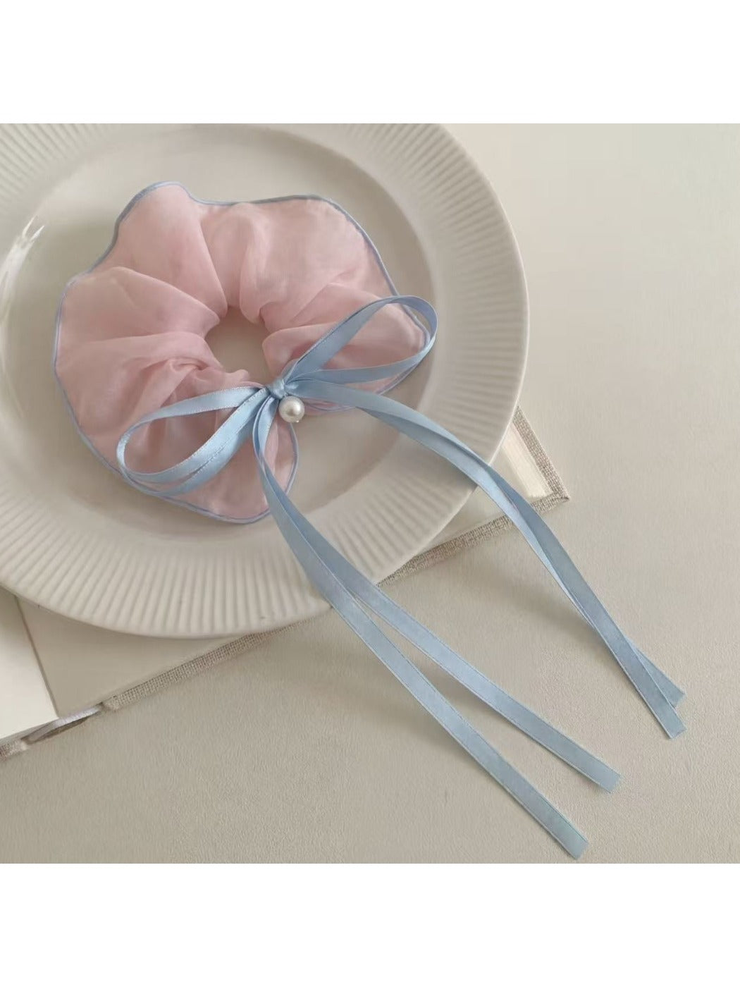 Gifty scrunchie displayed on a white background emphasizing bow and ruffles