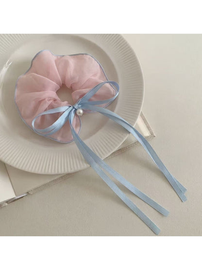 Gifty scrunchie displayed on a white background emphasizing bow and ruffles